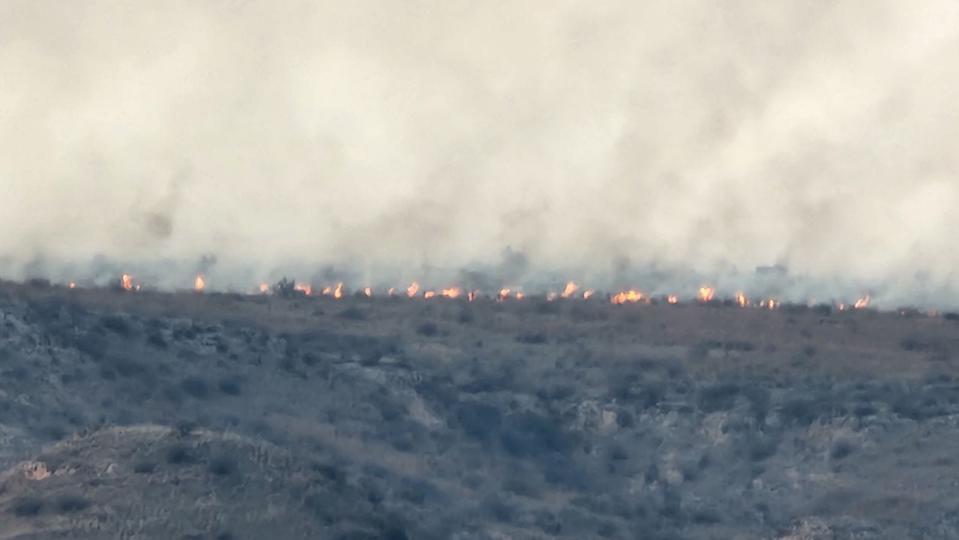 Terrain continues to smolder in the outlying boundaries of the Smokehouse Creek Fire, seen Wednesday near Miami, Texas. The fire, which was currently the second largest in state history, was an estimated 850,000 acres and 3 percent contained as of 6 p.m. Wednesday.