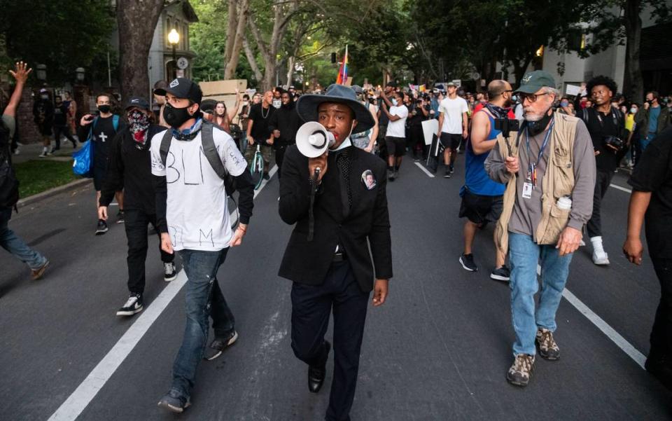 Sacramento Bee reporter Sam Stanton, right, follows Stevante Clark and streams live on social media at a peaceful protest in Sacramento on Monday, June 1, 2020, after days of heated demonstrations after the death of George Floyd, who was killed while in Minneapolis police custody on Memorial Day.
