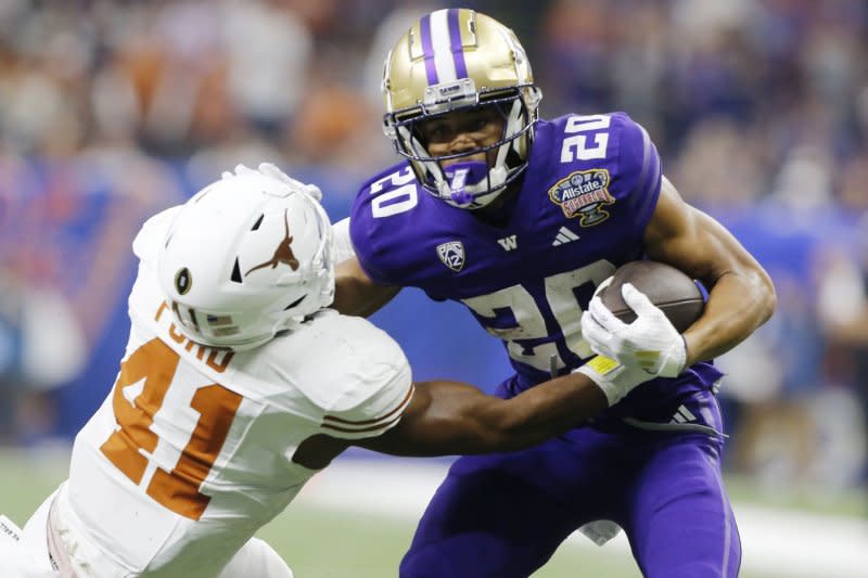Washington Huskies running back Tybo Rogers (R) pushes off Texas Longhorns linebacker Jaylan Ford in the first quarter of the Sugar Bowl on Monday in Caesars Superdome in New Orleans. Photo by AJ Sisco/UPI