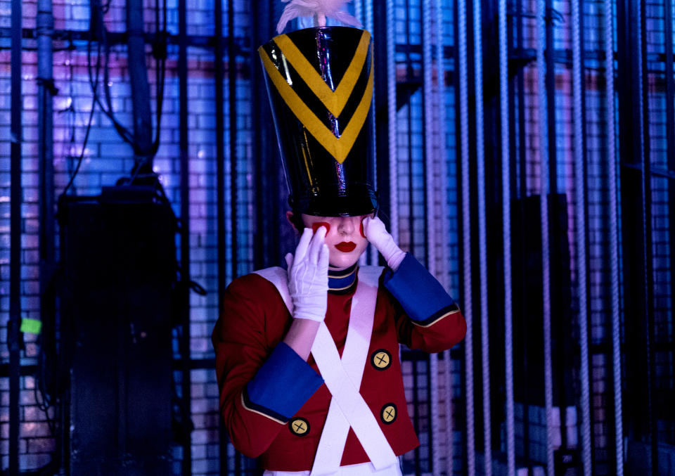 In this Monday, Nov. 25, 2019 photo, Rockette Sydney Mesher adjusts part of her Wooden Solider costume backstage during a performance of the Christmas Spectacular at Radio City Music Hall in New York. Mesher, who was born without a left hand due to the rare congenital condition symbrachydactyly, is the first person with a visible disability ever hired by New York's famed Radio City Rockettes. (AP Photo/Craig Ruttle)