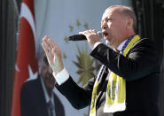 Turkey's President Recep Tayyip Erdogan sings a political song before his address to the supporters of his ruling Justice and Development Party, AKP, during a rally in Ankara, Turkey, Saturday, March 23, 2019, ahead of local elections scheduled for March 31, 2019. (AP Photo/Burhan Ozbilici)