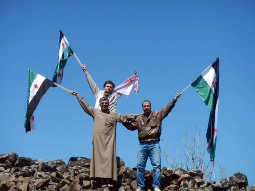 Picture from the Syrian opposition's Shaam News Network April 13, shows protesters waving flags during a demonstration against President Bashar al-Assad in Kfarnabel in Idlib province. AFP is using pictures from alternative sources as it was not authorised to cover this event and is not responsible for alterations that cannot be independently verified