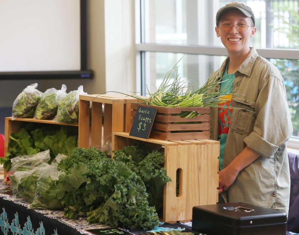 Em Evans of Living City Farms waits for customers at the Summit Lake Neighborhood Farmers Market.