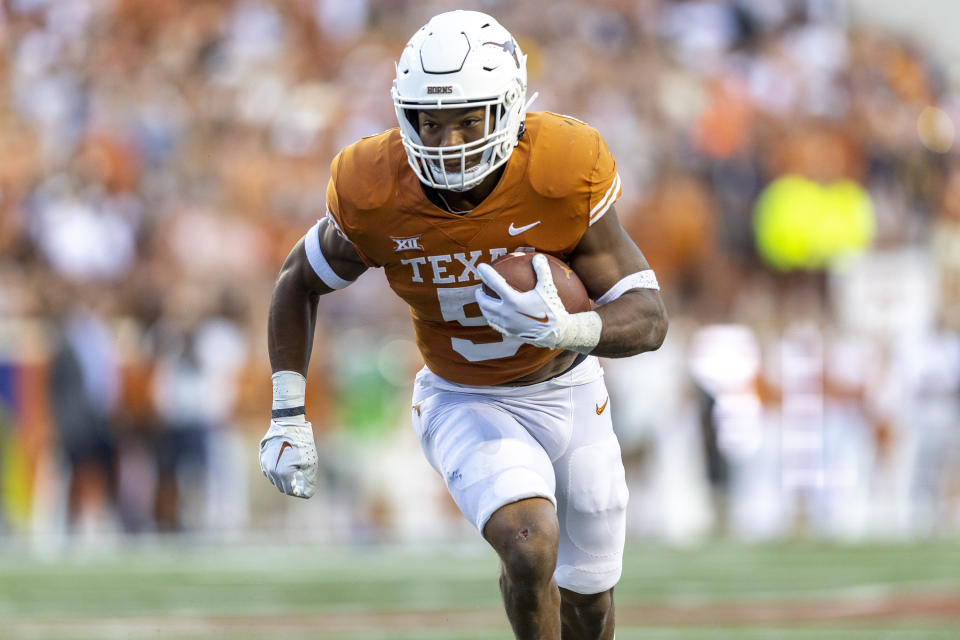 Texas running back Bijan Robinson carries against West Virginia during the first half of an NCAA college football game Saturday, Oct. 1, 2022, in Austin, Texas. (AP Photo/Stephen Spillman)