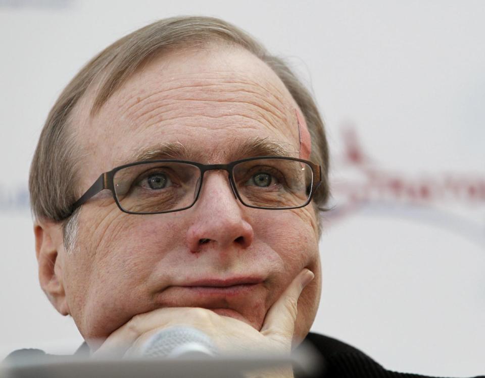 FILE - In this Dec. 13, 2011 photo, Microsoft co-founder Paul Allen listens during a a news conference in Seattle. An AWOL soldier’s simple scheme to defraud one of the richest men in the world has landed him in federal custody, according to a criminal complaint. In the complaint unsealed Monday, March 26, 2012, federal investigators allege Brandon Lee Price changed the address on a bank account held by billionaire Microsoft co-founder Paul Allen, then had a debit card sent to his Pittsburgh home so he could use it for payments on a delinquent Armed Forces Bank account and personal expenses. (AP Photo/Elaine Thompson)