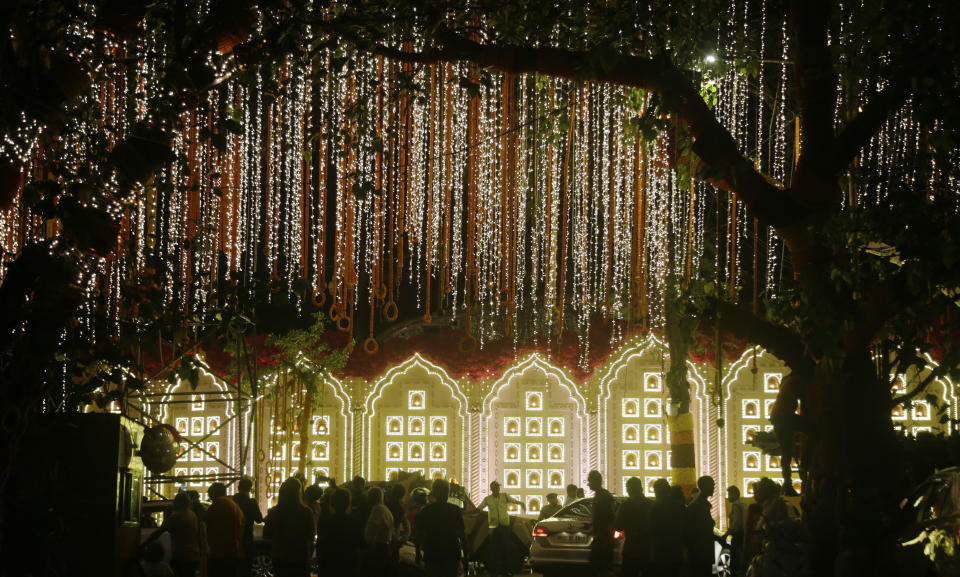 A street is lit-up outside the house of Reliance Industries Chairman Mukesh Ambani ahead of the wedding of his daughter Isha in Mumbai, India, Tuesday, Dec. 11, 2018. Isha Ambani, the daughter of India’s richest mogul, is to wed Anand Piramal, the son of one of India’s biggest industrialists, at the Ambani estate in Mumbai on Wednesday, capping off an extravagant days-long event. (AP Photo/Rajanish Kakade)