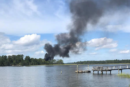 Smoke rises at the site of a F-35 jet crash in Beaufort, South Carolina, U.S., September 28, 2018 in this still image obtained from social media. KENSLEY MINCEY CROSBY/via REUTERS