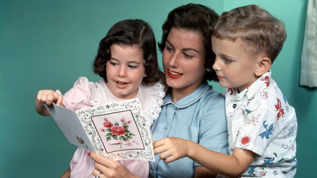 1950s MOTHER LOOKING AT...