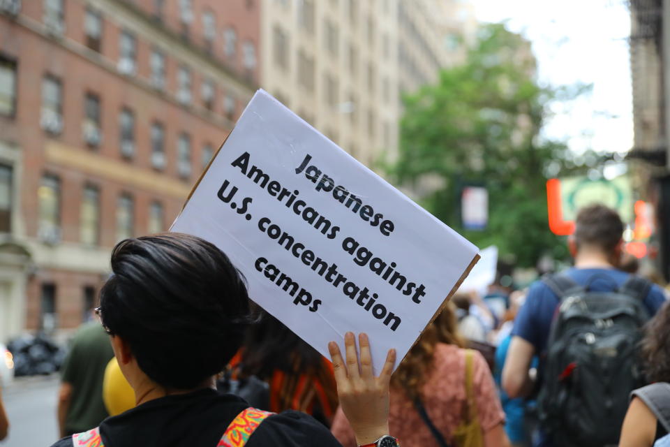 <p>A protester holds up a sign that reads “Japanese Americans against U.S. concetration camps” while marching toward the United Nations in New York City on June 20, 2018. (Photo: Gordon Donovan/Yahoo News) </p>