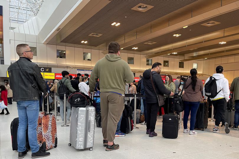 Passengers queue for check in at Manchester Airport's terminal 2 on April 04, 2022 in Manchester, United Kingdom