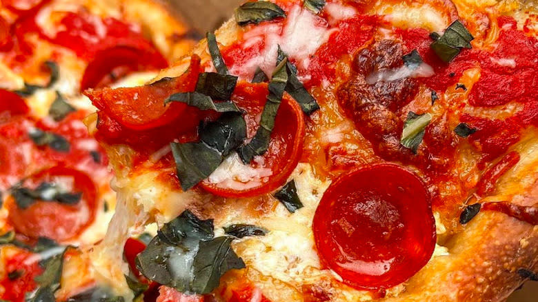 close up pizza pepperoni basil