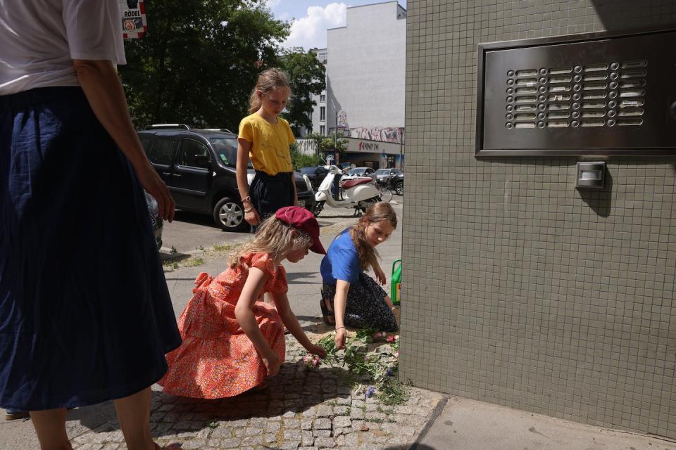 Children place flowers at a Berlin memorial commemorating a Jewish family killed in World War II. <a href="https://media.gettyimages.com/id/1324757639/photo/locals-research-and-commemorate-a-jewish-family-murdered-in-the-holocaust.jpg?s=612x612&w=gi&k=20&c=IbqLnLSWV-bwuA_yy5ZGDZk1xitY9gii1eaHo7z3kbI=" rel="nofollow noopener" target="_blank" data-ylk="slk:Sean Gallup/Getty Images;elm:context_link;itc:0;sec:content-canvas" class="link ">Sean Gallup/Getty Images</a>