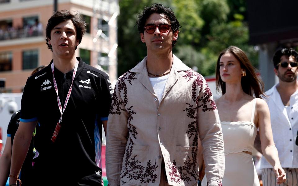 Musician Joe Jonas walking through the pitlane