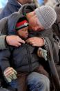 <p>On another trip to Lesotho in 2010, the prince helps a young boy to do up his jacket.</p>