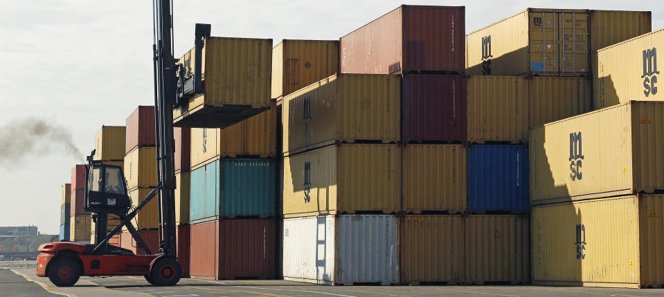 FILE - In this Nov. 8, 2011 photo, shipping containers are moved at Massport's Conley Terminal in Boston. The U.S. trade deficit fell to its lowest level in 18 months in June, pushed down by a steep drop in oil imports and a small rise in exports. the Commerce Department said Thursday, Aug. 9, 2012 that the trade gap narrowed to $42.9 billion in June, down from $48 billion in May. (AP Photo/Charles Krupa, File)