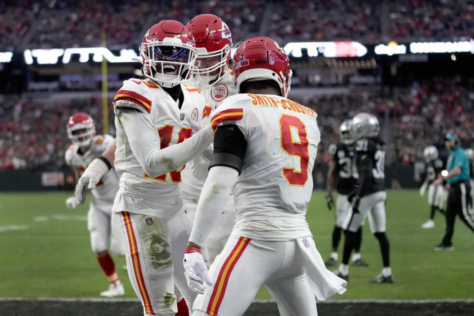 Kansas City Chiefs wide receiver Kadarius Toney, left, is congratulated by JuJu Smith-Schuster (9) after scoring on a touchdown run during the first half of an NFL football game against the Las Vegas Raiders Saturday, Jan. 7, 2023, in Las Vegas. (AP Photo/John Locher)