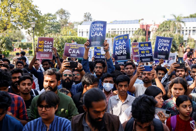 Students of Jamia Millia Islamia University from different student organizations hold placards against a citizenship law during a press conference held inside the university in New Delhi