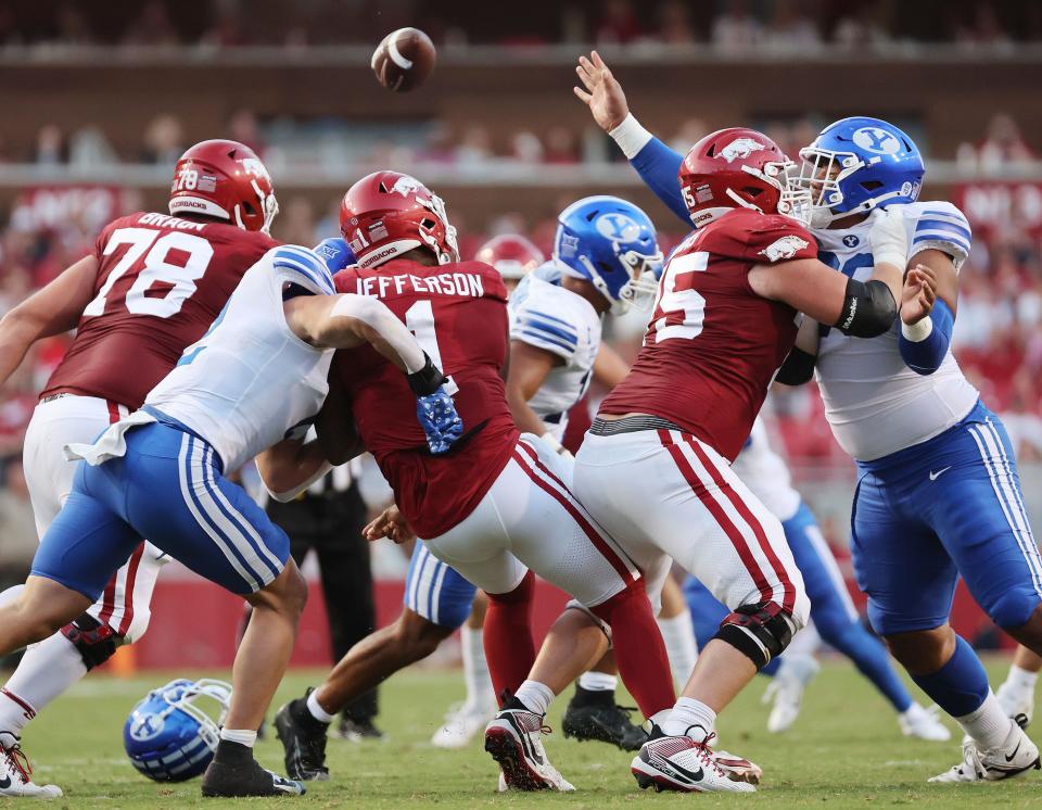 The BYU defense hurries Arkansas Razorbacks quarterback KJ Jefferson (1) at Razorback Stadium in Fayetteville on Saturday, Sept. 16, 2023. | Jeffrey D. Allred, Deseret News