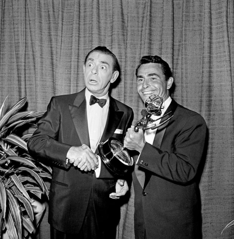 <p>Comedian Eddie Cantor shakes the hand of <em>Twilight Zone </em>creator and Emmy-winner Rod Serling. The mystery anthology series collected three Emmys during its original run.</p>