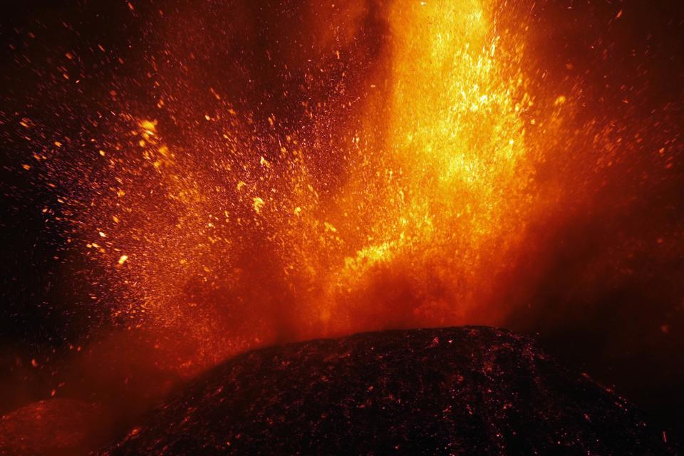 Italy's Mount Etna, Europe's tallest and most active volcano, spews lava as it erupts on the southern island of Sicily November 17, 2013. There were no reports of damage or evacuations in the area and the nearby airport of Catania was operating as normal, local media reported. It is the 16th time that Etna has erupted in 2013. The south-eastern crater, formed in 1971, has been the most active in recent years. REUTERS/Antonio Parrinello (ITALY - Tags: ENVIRONMENT SOCIETY)