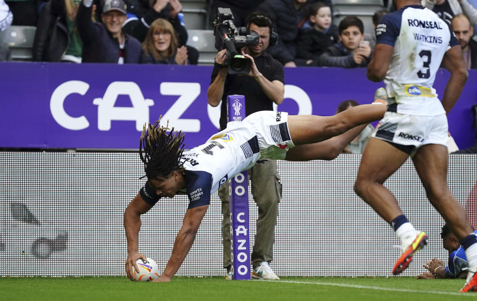 England's Dominic Young dives in to score his side's third try, during the Rugby League World Cup group A match between England and Samoa, at St James' Park, in Newcastle upon Tyne, England, Saturday, Oct. 15, 2022. (Mike Egerton/PA via AP)