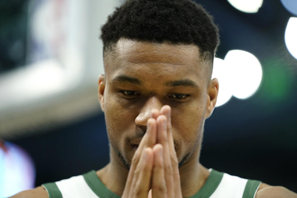 Milwaukee Bucks' Giannis Antetokounmpo pauses before an NBA basketball game against the Houston Rockets, Sunday, Dec. 17, 2023, in Milwaukee. (AP Photo/Aaron Gash)