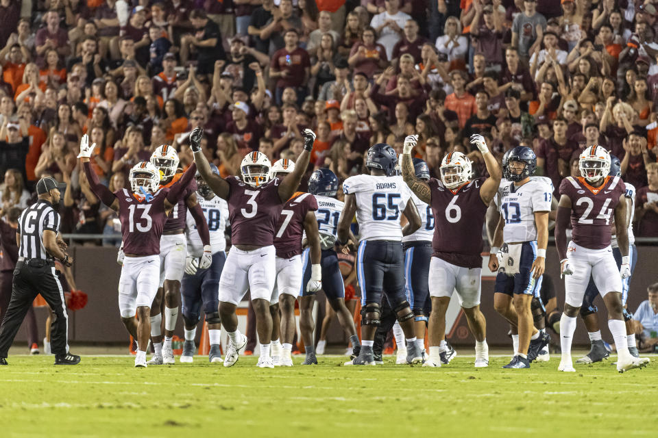 Virginia Tech's Josh Fugan (6), Jaden Keller (24) and Norell Pollard (3) celebrate a stop against Old Dominion during the first half of an NCAA college football Saturday, Sept. 2, 2023, in Blacksburg, Va. (AP Photo/Robert Simmons)