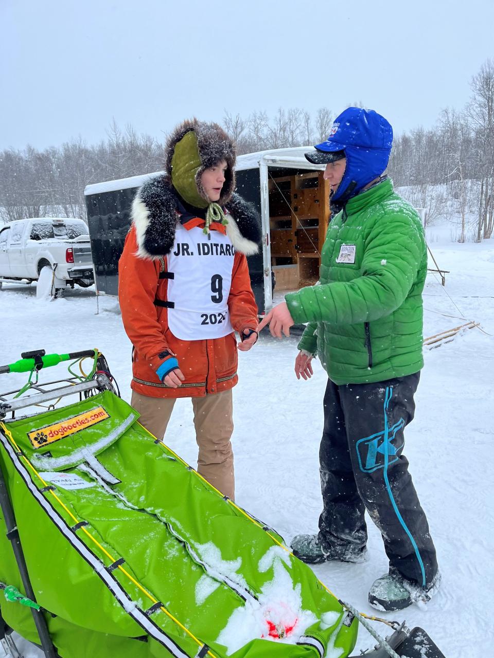 Morgan Martens, left, gets some strategy tips from 2023 Iditarod champion Ryan Redington, before the younger musher sets of in the Junior Iditarod race. Redington has been an influential mentor in Martens' mushing career.