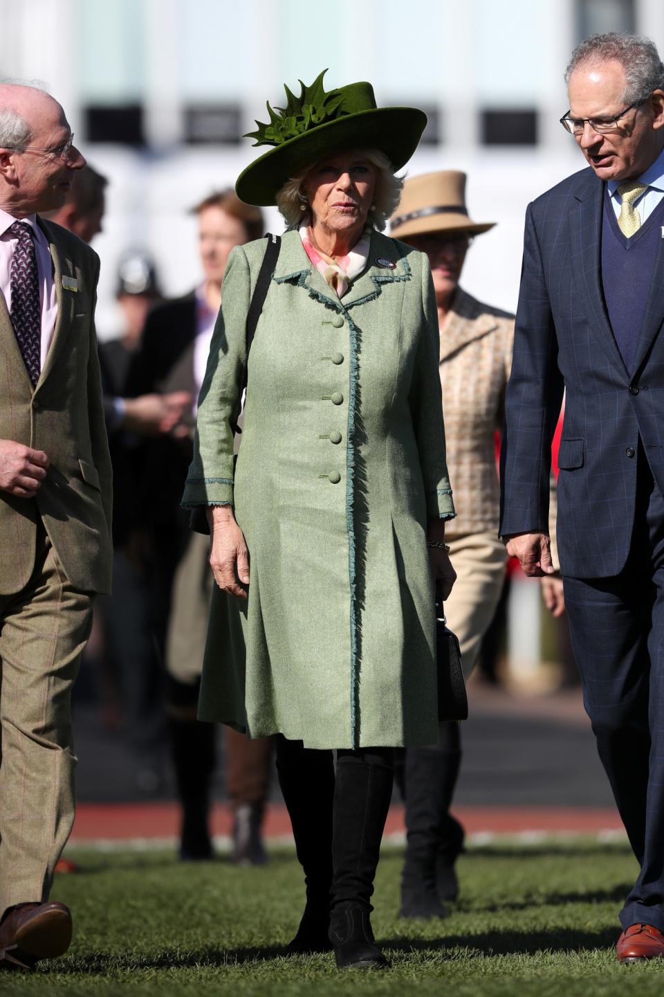 <p>Camilla’s gone for two shades of green, including a coat with fringing detail and a hat in a richer shade [Photo: PA] </p>