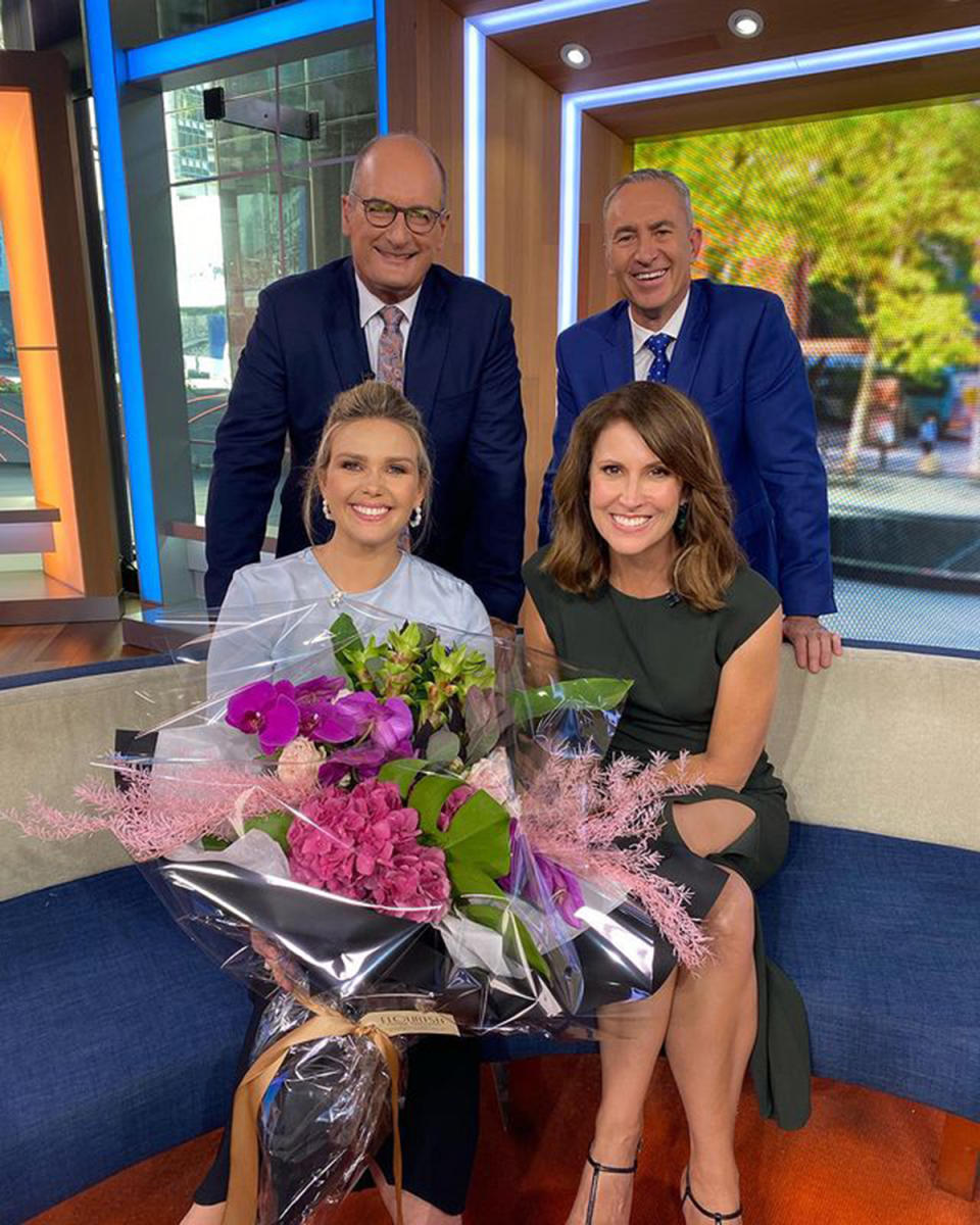 Sunrise host Edwina Bartholomew holds a bunch of flowers while posing with her co-hosts David Koch, Mark Beretta and Nat Barr. Photo: Instagram/edwina_b.