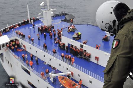 An Italian Navy member looks out from helicopter as the car ferry Norman Atlantic burns in waters off Greece December 28, 2014 in this handout photo provided by Marina Militare. REUTERS/Marina Militare/Handout via Reuters