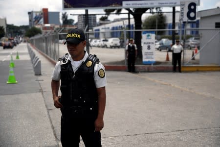 Guatemalan Civil National Police patrol pick-up truck secure an entrance at the official voting result center ahead of the second round run-off vote, in Guatemala City