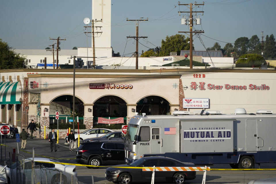Investigators are seen outside Star Dance Studio in Monterey Park, Calif., Sunday, Jan. 22, 2023. A mass shooting took place at the dance club following a Lunar New Year celebration, setting off a manhunt for the suspect. (AP Photo/Jae C. Hong)