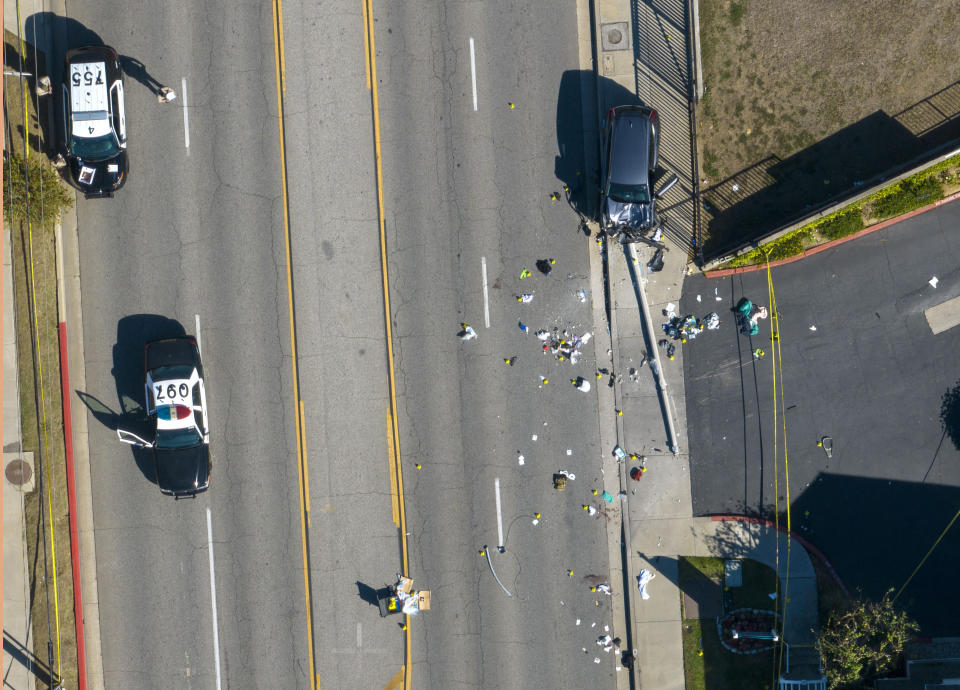 Investigators work the scene where 25 Los Angeles County sheriff’s academy recruits on a training run were hit by a vehicle that veered onto the wrong side of the road on Wednesday, Nov. 16, 2022, in Whittier, Calif. (Jeff Gritchen/The Orange County Register via AP)