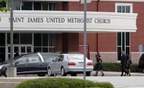 Mourners arrive near a hearse for the funeral of Kristina Bobbi Brown, the only child of singer Whitney Houston at Saint James United Methodist Church in Alpharetta, Georgia, August 1, 2015. REUTERS/Tami Chappell