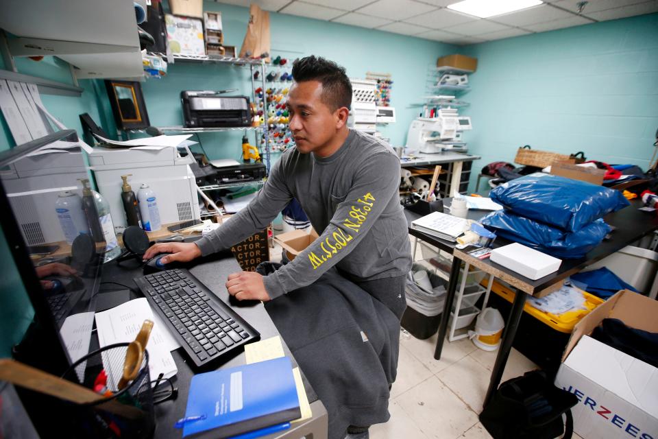 Carlos Chamorro, owner, prepares an embroidery project he is working on at the recently opened Ocean Drive Screenprinting on MacArthur Drive in New Bedford.