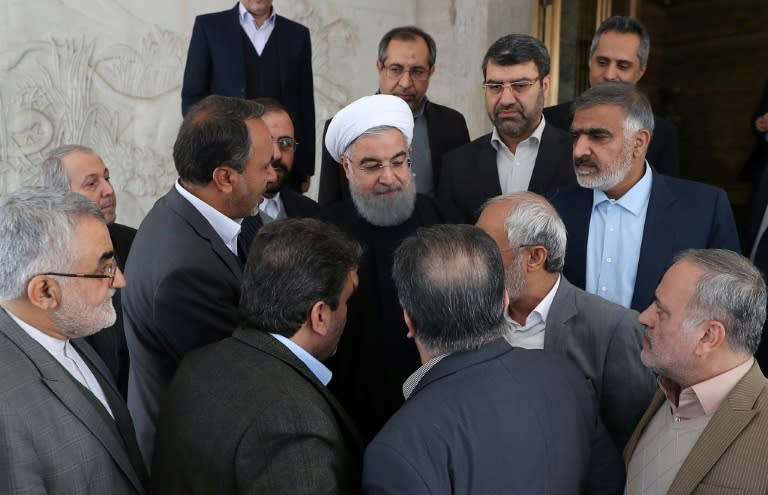 Many have called on Iran's President Hassan Rouhani (C) to address the economic grievances that sparked days of deadly unrest