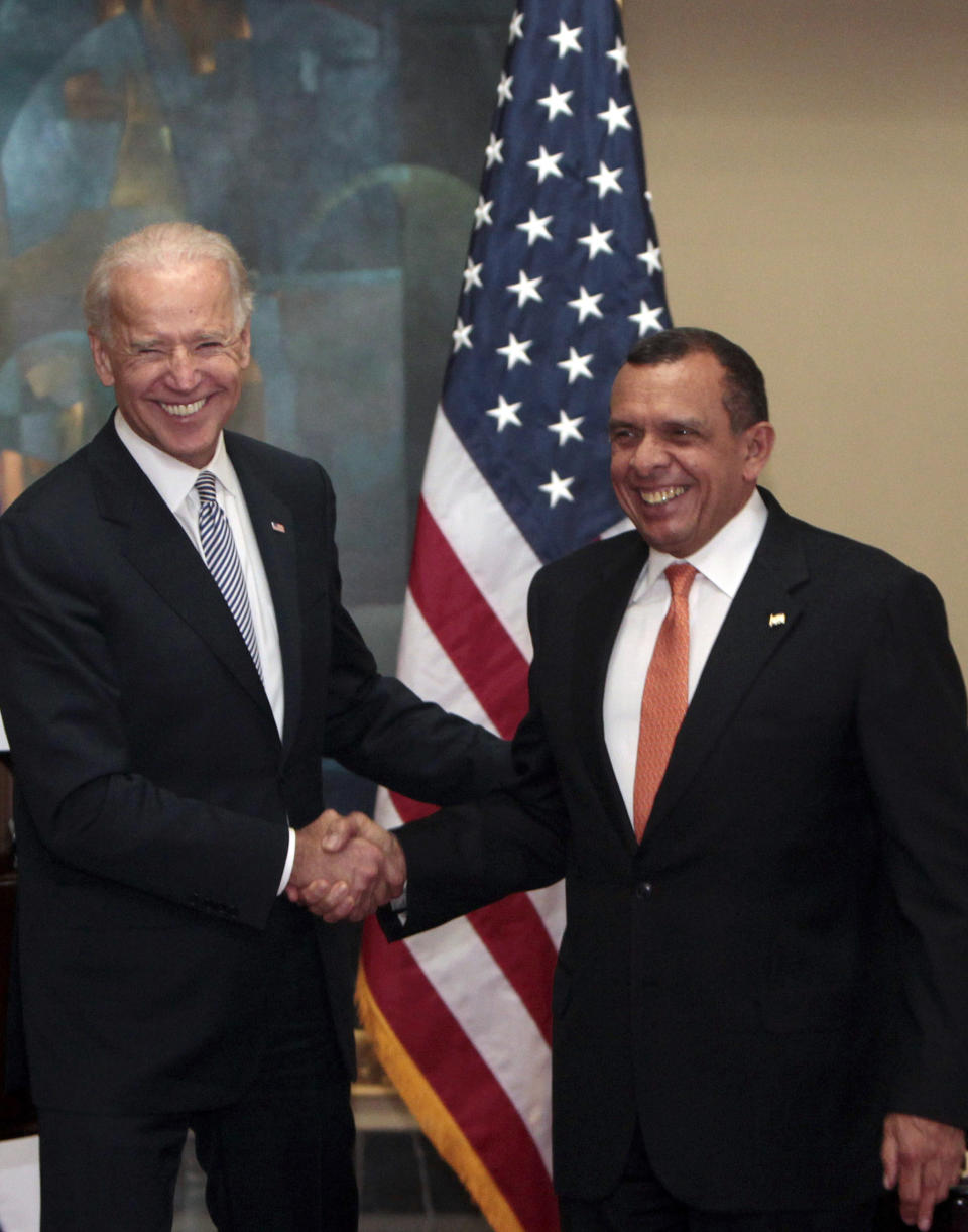 U.S. Vice President Joe Biden, left, and Honduras' President Porfirio Lobo shake hands as they pose for pictures during a meeting at the presidential house in Tegucigalpa, Honduras, Tuesday, March, 6, 2012. Biden is on a one-day visit to Honduras. (AP Photo/Esteban Felix)