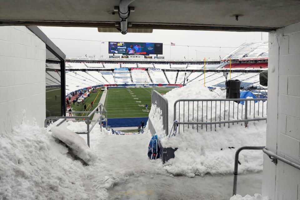 A view from inside the concourse of Highmark Stadium on Monday afternoon before the AFC wild-card game between the Buffalo BIlls and Pittsburgh Steelers. Snow has been cleared from the field and piles of snow have been shoveled in the walkways and stands.