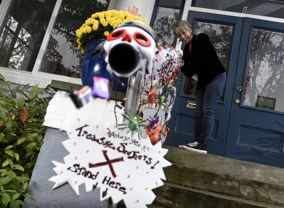 Carol McCarthy sends candy down the candy chute that she will use to give out treats to socially-distant trick-or-treaters on Halloween, Monday, Oct. 26, 2020, in Palmyra, N.J. (AP Photo/Michael Perez)