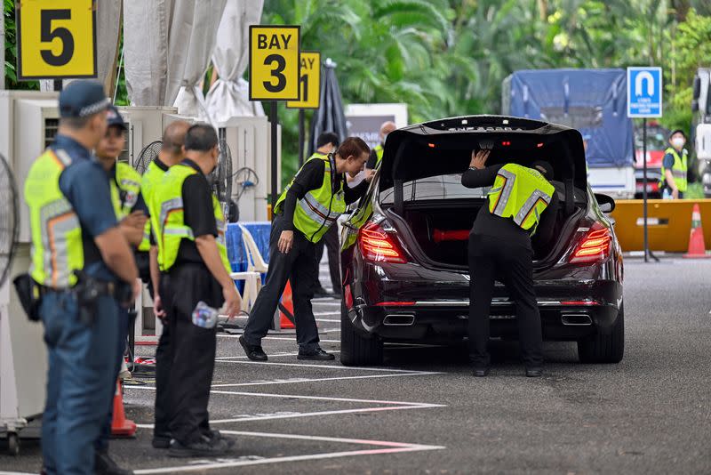 Security personnel check vehicles entering the venue of the 20th Shangri-La Dialogue in Singapore