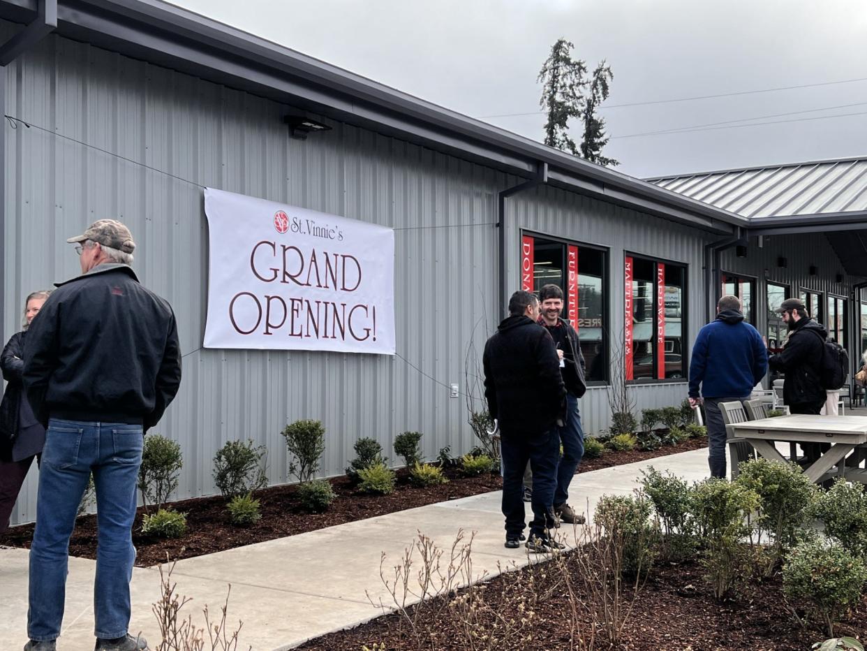 People gather outside of the new St. Vincent de Paul retail location at 910 Row River Road in Cottage Grove on Thursday morning to celebrate the grand opening.