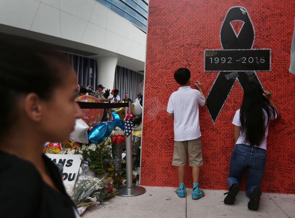 <p>People sign a memorial wall as they wait for the hearse carrying Miami Marlins pitcher Jose Fernandez to pass in front of the Marlins baseball stadium on September 28, 2016 in Miami, Florida. Mr. Fernandez was killed in a weekend boat crash in Miami Beach along with two friends. (Photo by Joe Raedle/Getty Images) </p>