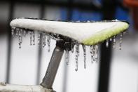 A bicycle seat is covered with ice after freezing rain in Toronto, Ontario December 22, 2013. Thousands of households are without power in the Greater Toronto area following an overnight ice storm. REUTERS/Hyungwon Kang (CANADA - Tags: ENVIRONMENT)