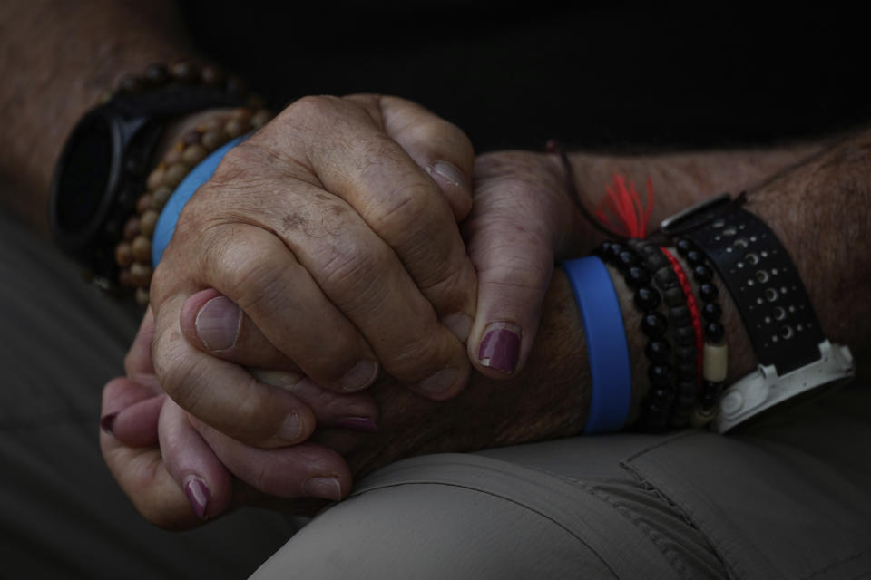 Mourners hold hands during the funeral of Sgt. Yam Goldstein and her father, Nadav, in Kibbutz Shefayim, Israel, Monday, Oct. 23, 2023. Yam and her father were killed by Hamas militants on Oct. 7 at their house in Kibbutz Kfar Azza near the border with the Gaza Strip. The rest of the family are believed to be held hostage in Gaza. More than 1,400 people were killed and some 200 captured in an unprecedented, multi-front attack by the militant group that rules Gaza. (AP Photo/Ariel Schalit)