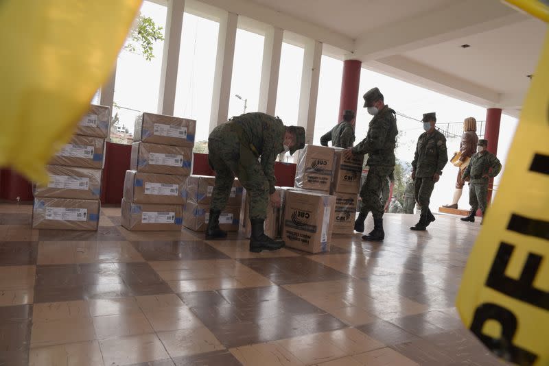 Soldiers handle electoral material at a polling station ahead of Ecuador's presidential election on February 7, in Quito