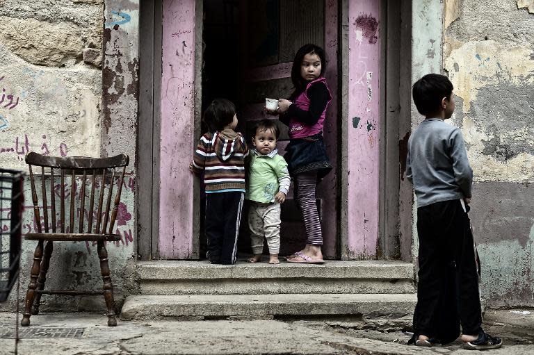 Children enter their apartment building at the prosfygika complex in central Athens on October 29, 2014