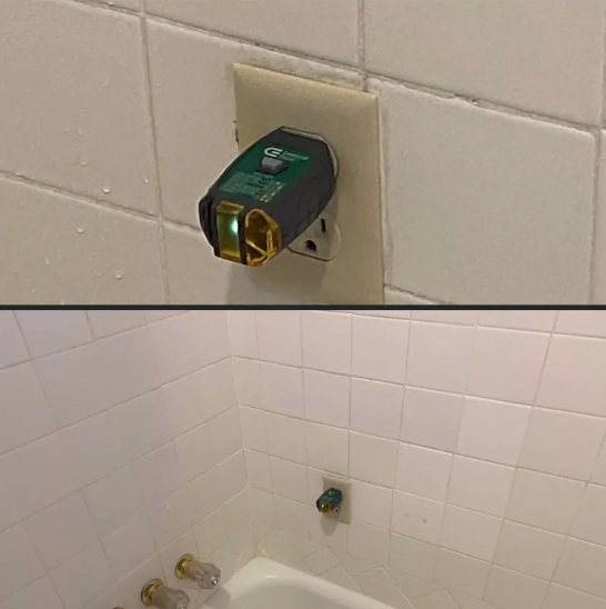 electric outlet placed on a tile in the bathtub