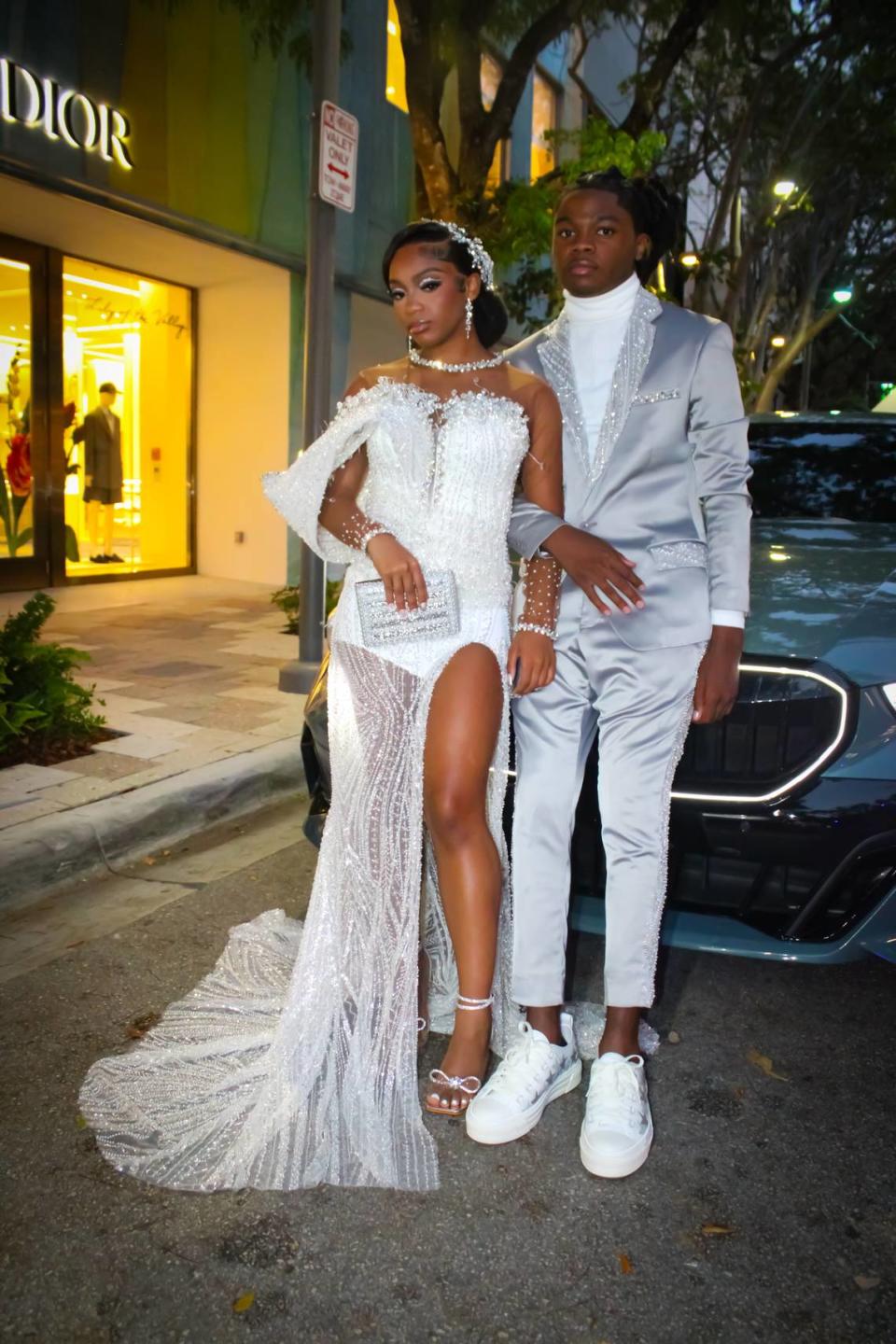 Miami Northwestern seniors Algieria Thomas (left) and her date Christien Webb (right) pose in the Design District prior to their prom on May 11, 2024. The two pulled up in a BWM 5 series while their classmates drove everything from Rolls Royces to Lamborghinis.
