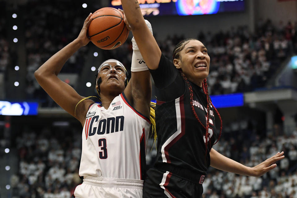 UConn's Aaliyah Edwards (3) shoots as South Carolina's Victaria Saxton (5) defends in the first half of an NCAA college basketball game, Sunday, Feb. 5, 2023, in Hartford, Conn. (AP Photo/Jessica Hill)